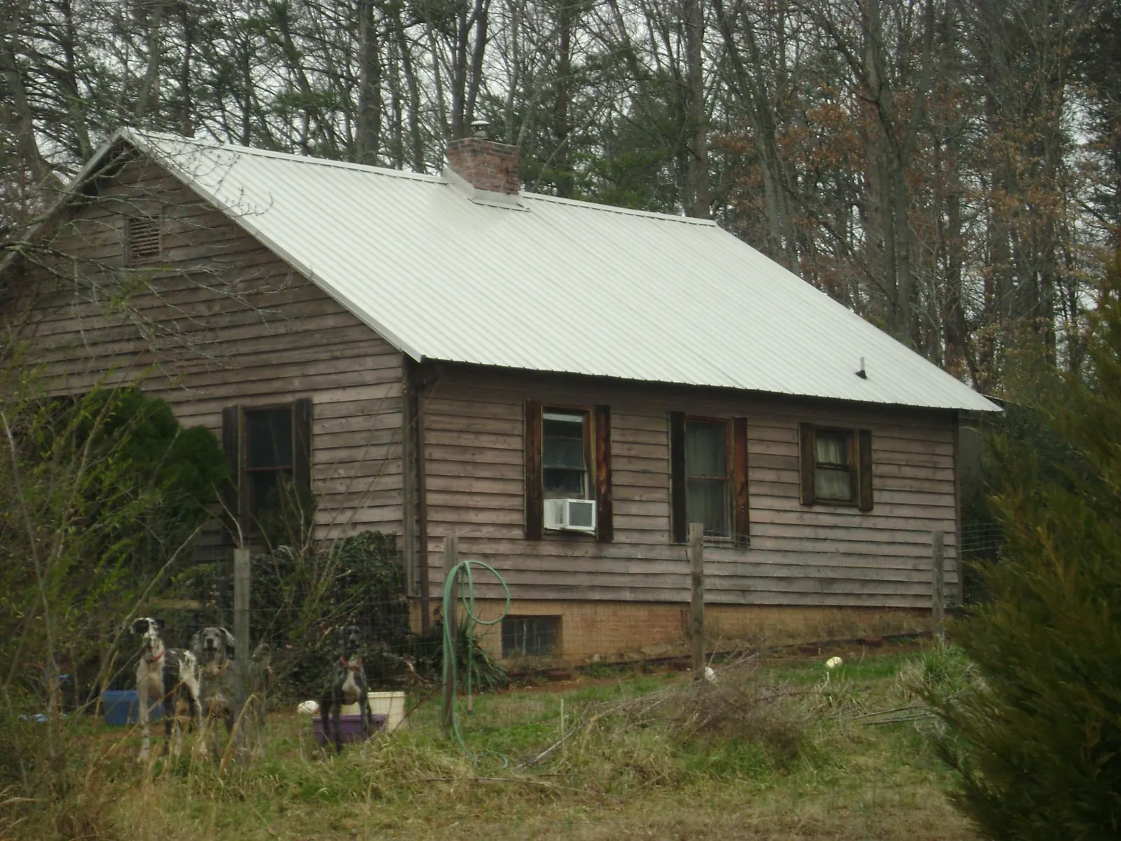 White metal roof on an old wood sided farmhouse, from a Asphalt Shingle Roof Repair job in Old Westbury